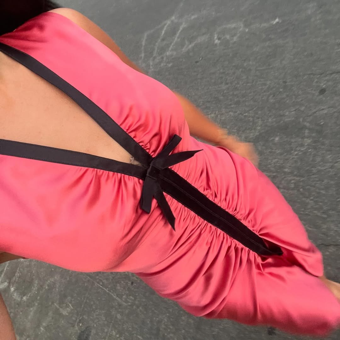 An influencer wearing a pink dress