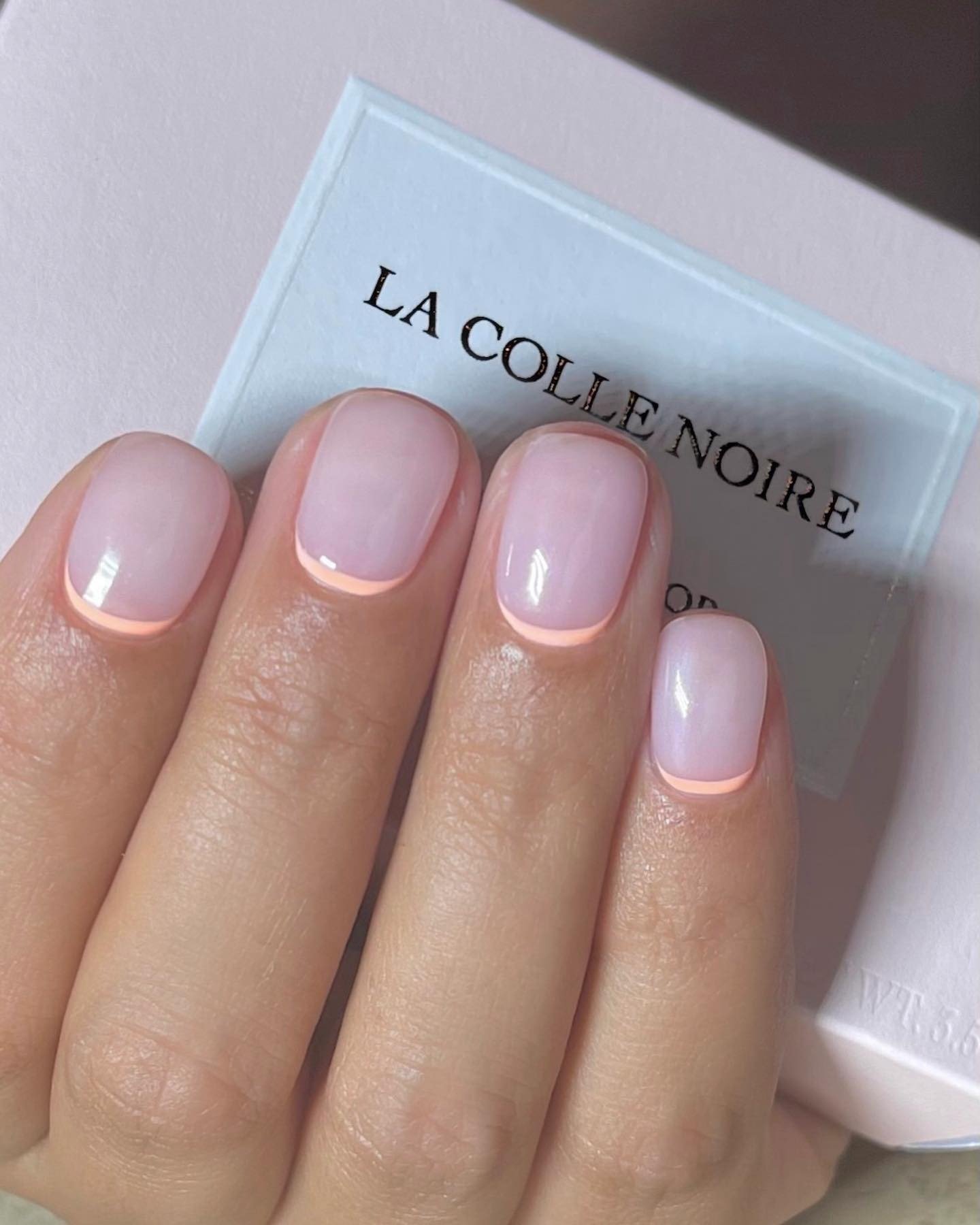 Reverse pastel orange French manicure