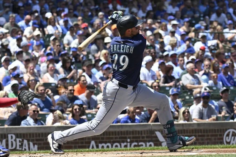Jun 20, 2025; Chicago, Illinois, USA; Seattle Mariners catcher Cal Raleigh (29) hits a home run against the Chicago Cubs during the first inning at Wrigley Field. Mandatory Credit: Matt Marton-Imagn Images