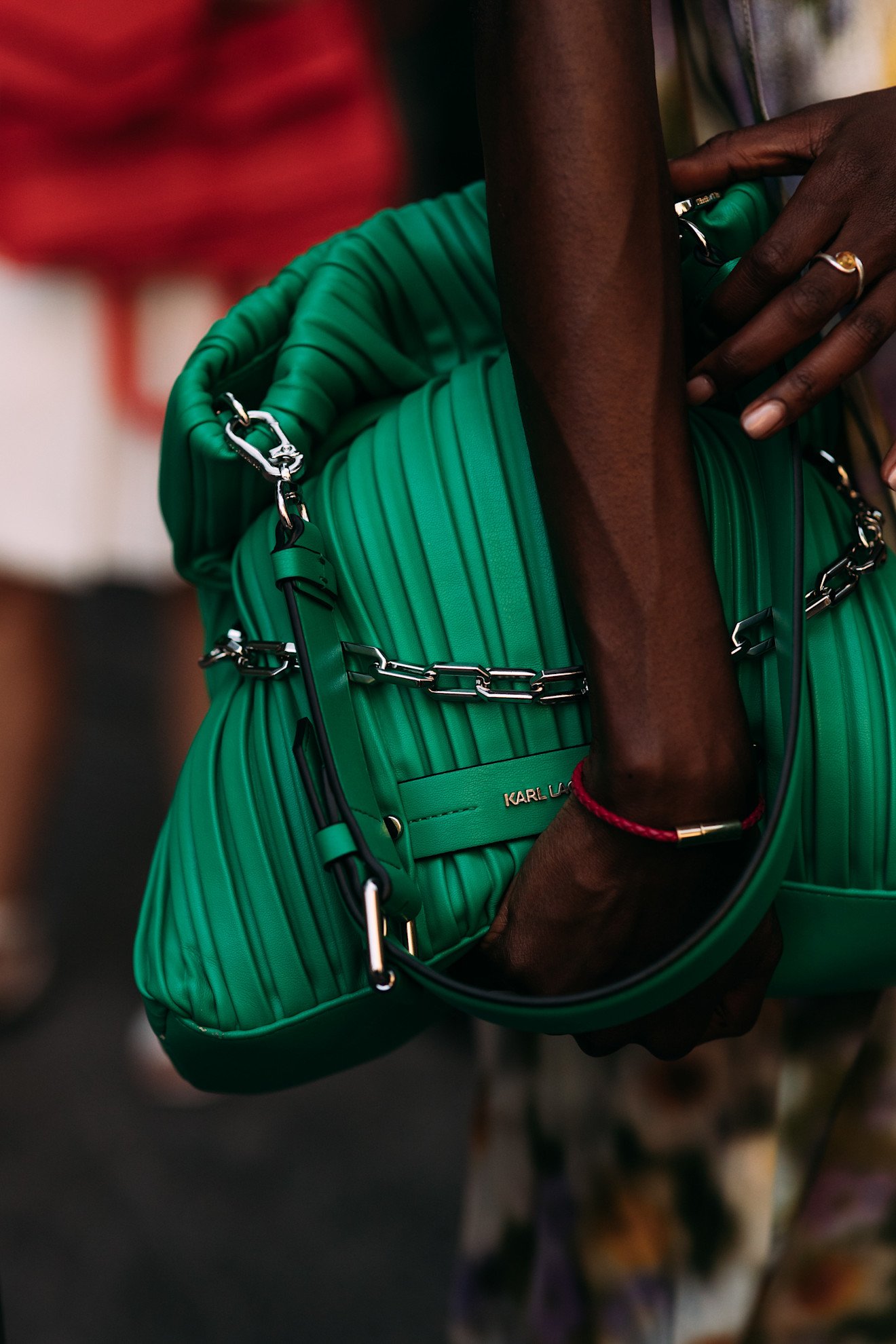 Milan Mens Fashion Week showgoer wears green in Milan.