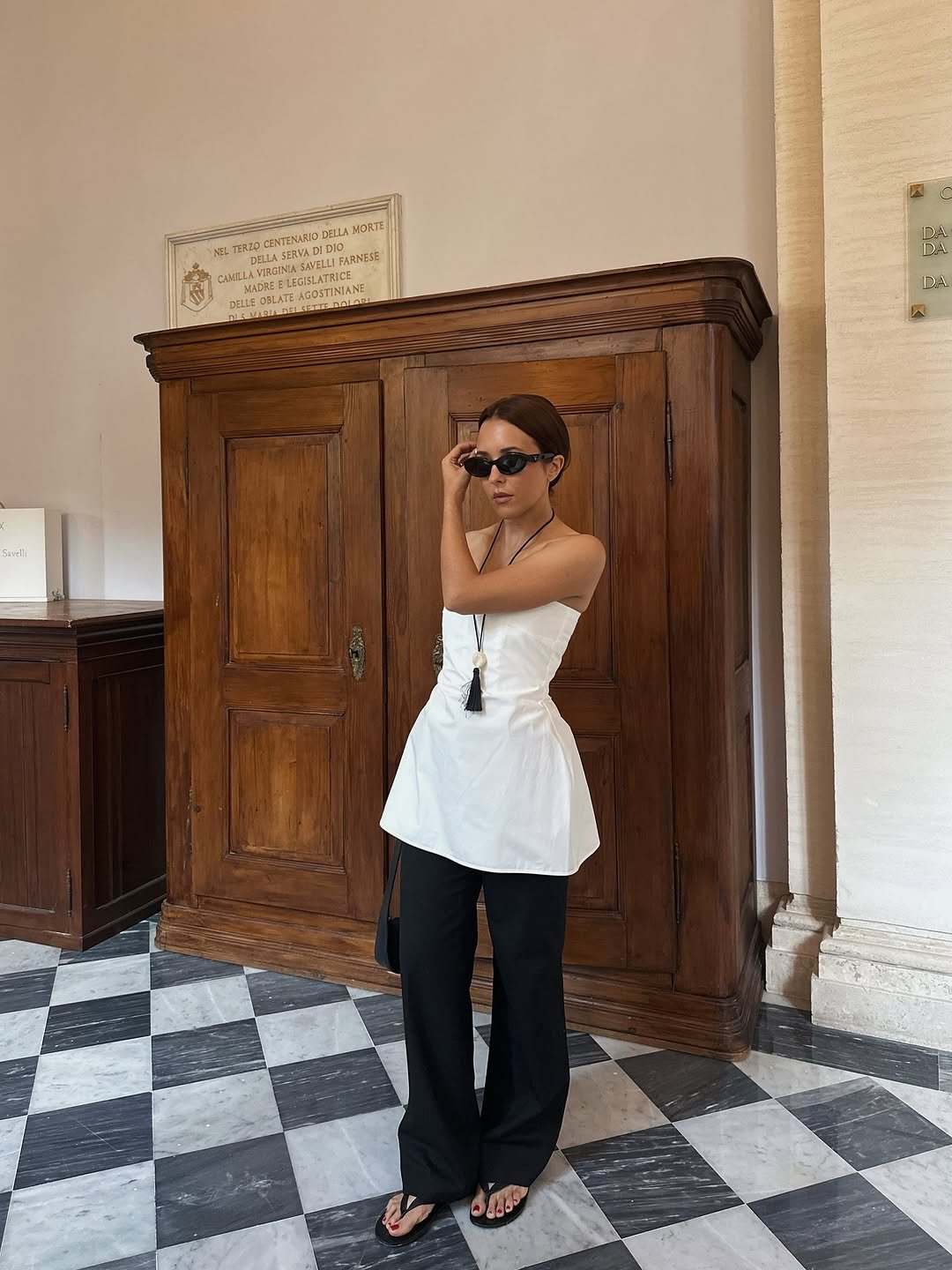 Woman wearing trouser pants and flip flops summer 2025.
