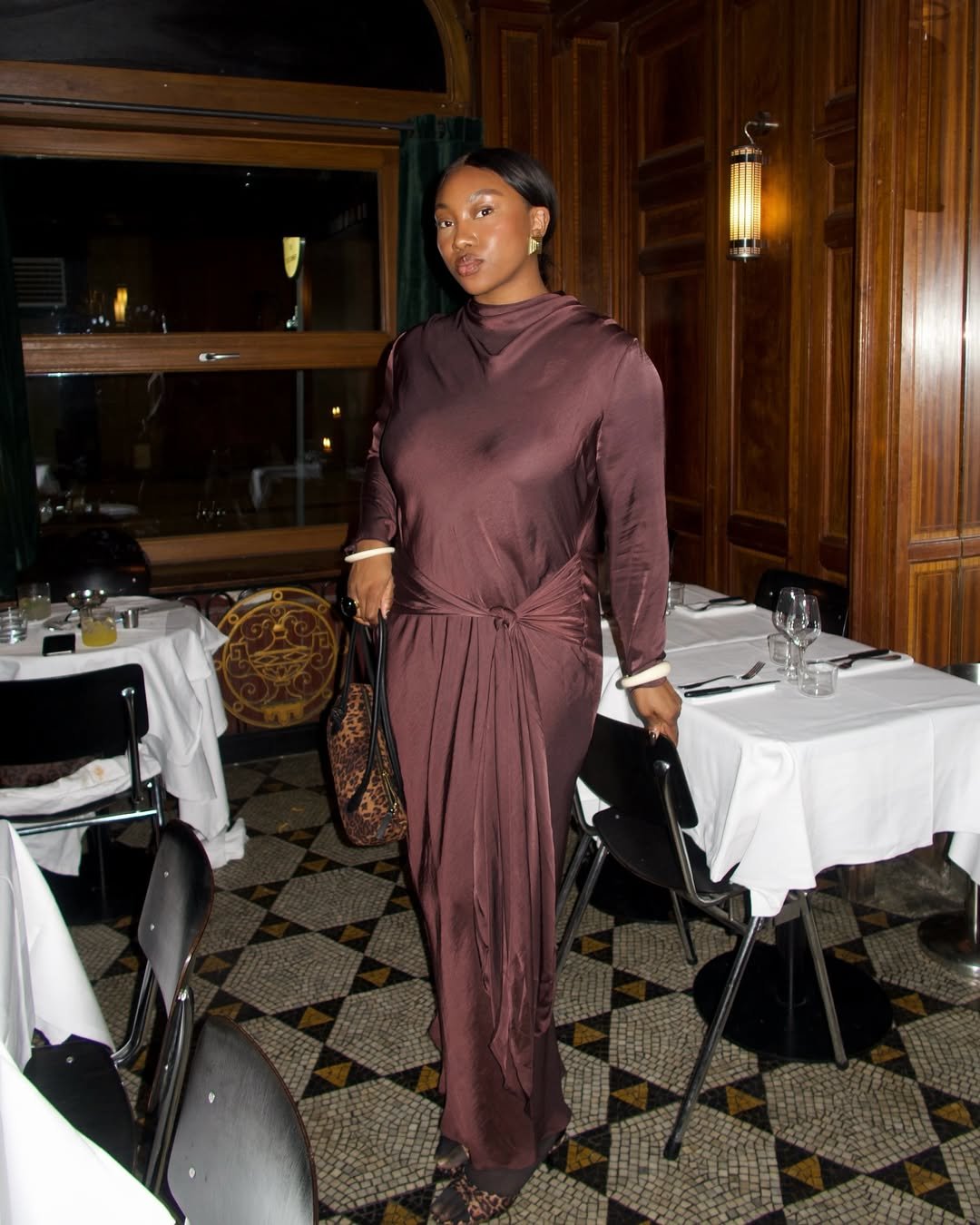 nnena wearing brown satin dress