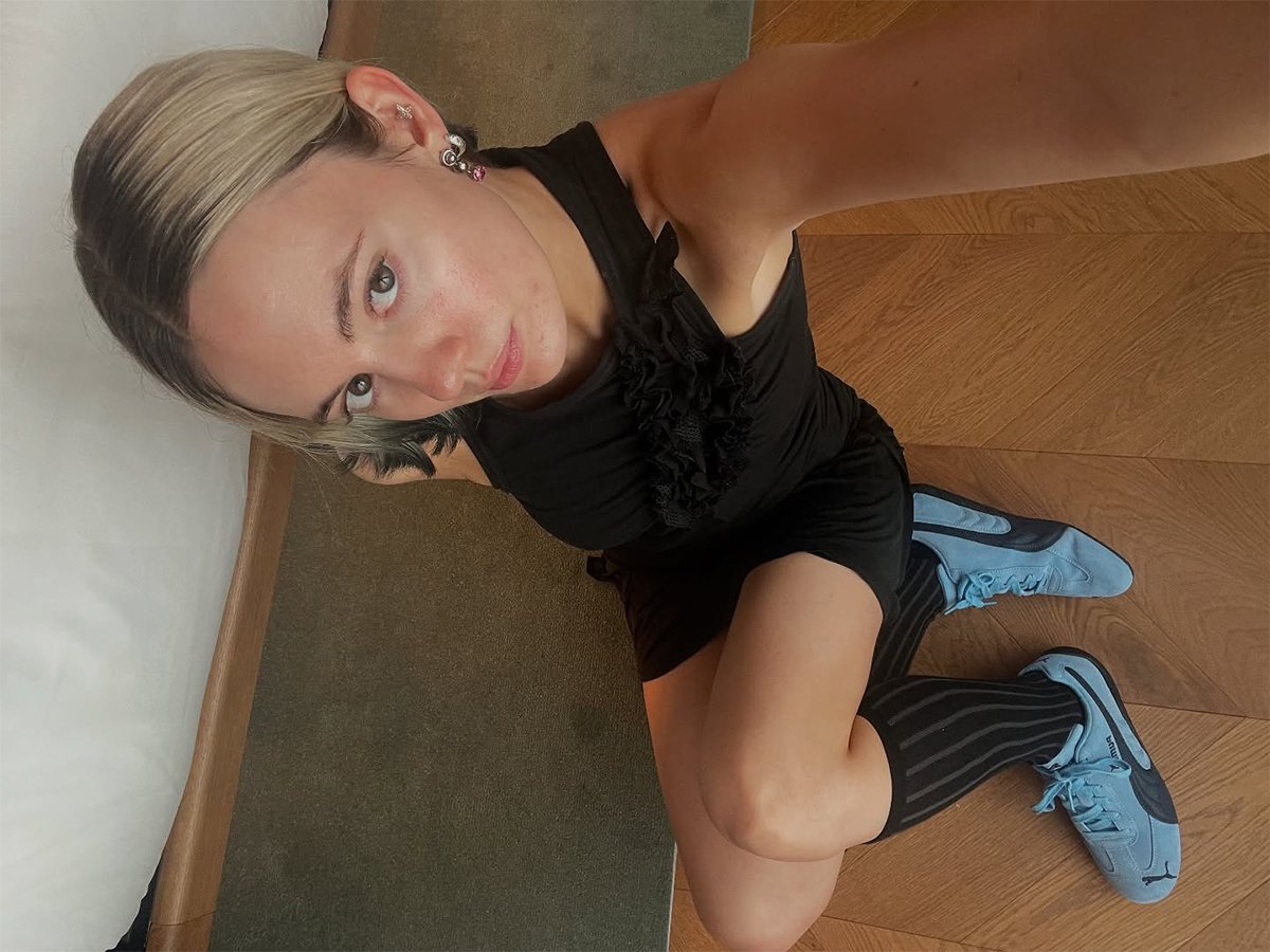 Influencer Susie Garvie wearing black and blue Puma sneakers.
