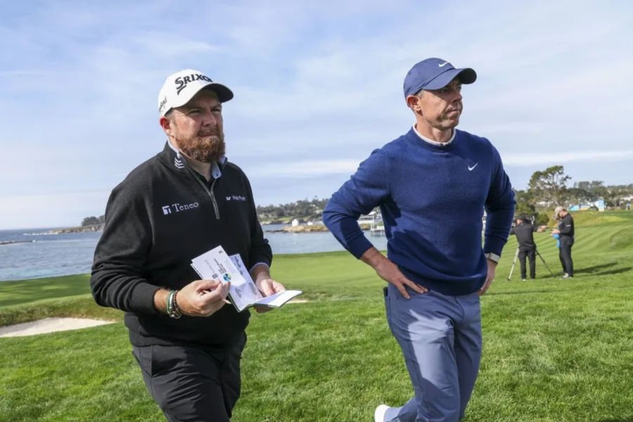 Feb 2, 2025; Pebble Beach, California, USA; Shane Lowry (left) and Rory McIlroy (right) on the fifth hole during the final round of the AT&T Pebble Beach Pro-Am golf tournament at Pebble Beach Golf Links. Mandatory Credit: Kiyoshi Mio-Imagn Images
