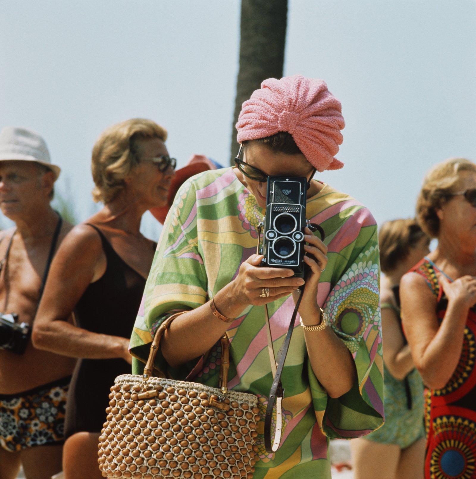 1972: Princess Grace of Monaco taking a photograph with a Rollei Magic twin lens reflex camera at a swimming competition at the Monte Carlo Beach Club near the Monte-Carlo Beach hotel. (Photo by Hulton Archive/Getty Images)