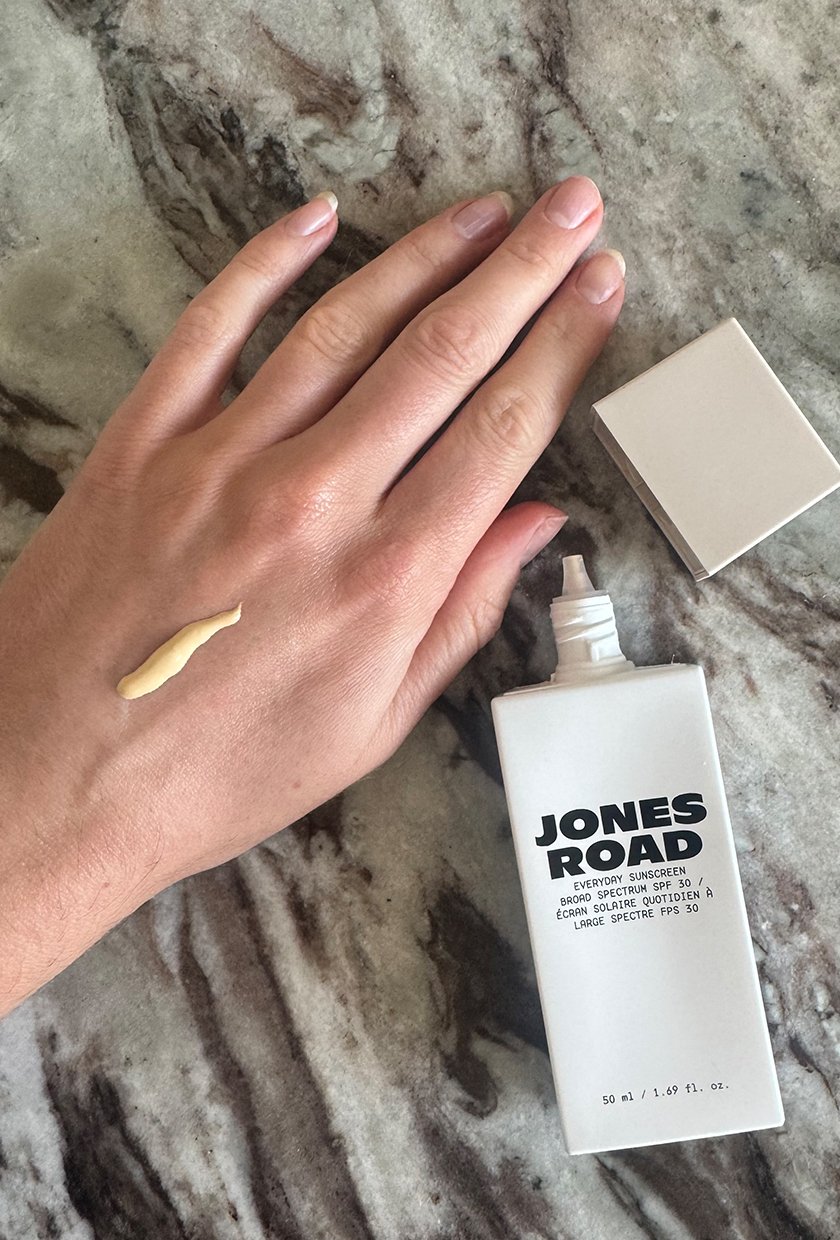 Eleanor testing the Jones Road Everyday Sunscreen in shade Sandy on the back of her hand