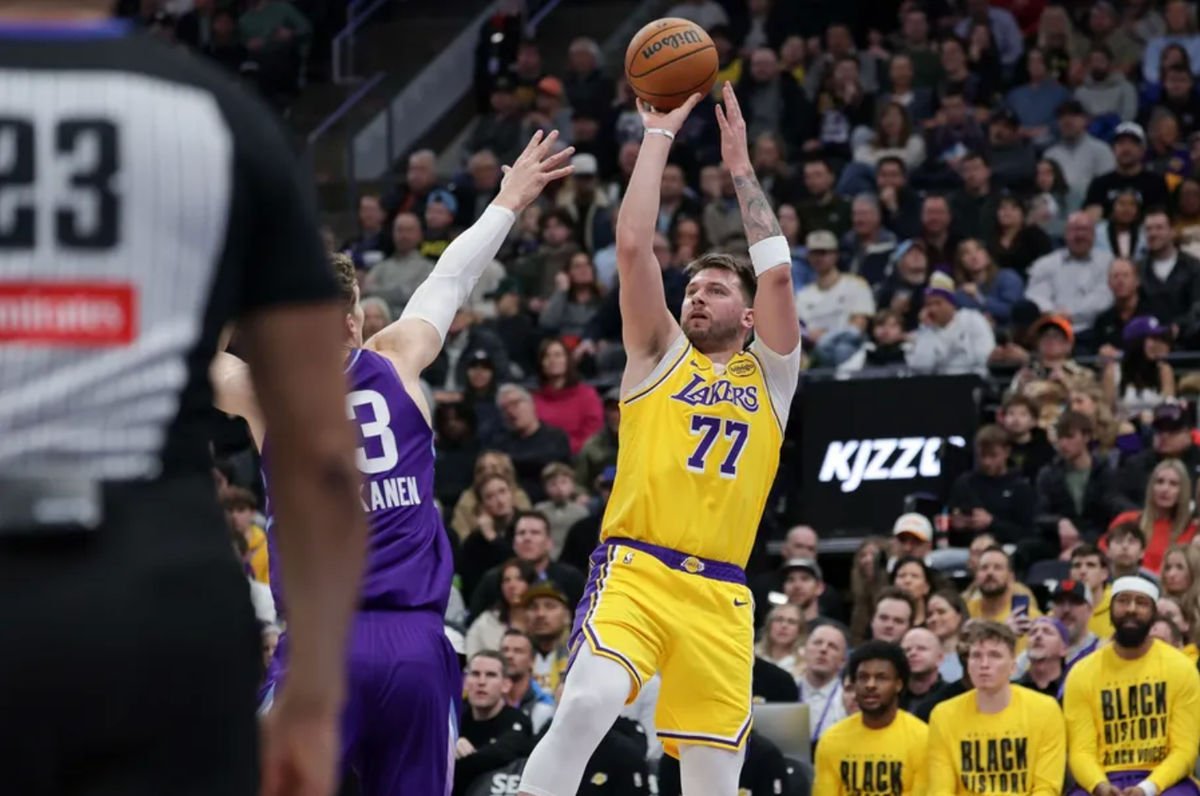 Feb 12, 2025; Salt Lake City, Utah, USA; Los Angeles Lakers guard Luka Doncic (77) shoots over Utah Jazz forward Lauri Markkanen (23) during the second quarter at Delta Center. Mandatory Credit: Chris Nicoll-Imagn Images