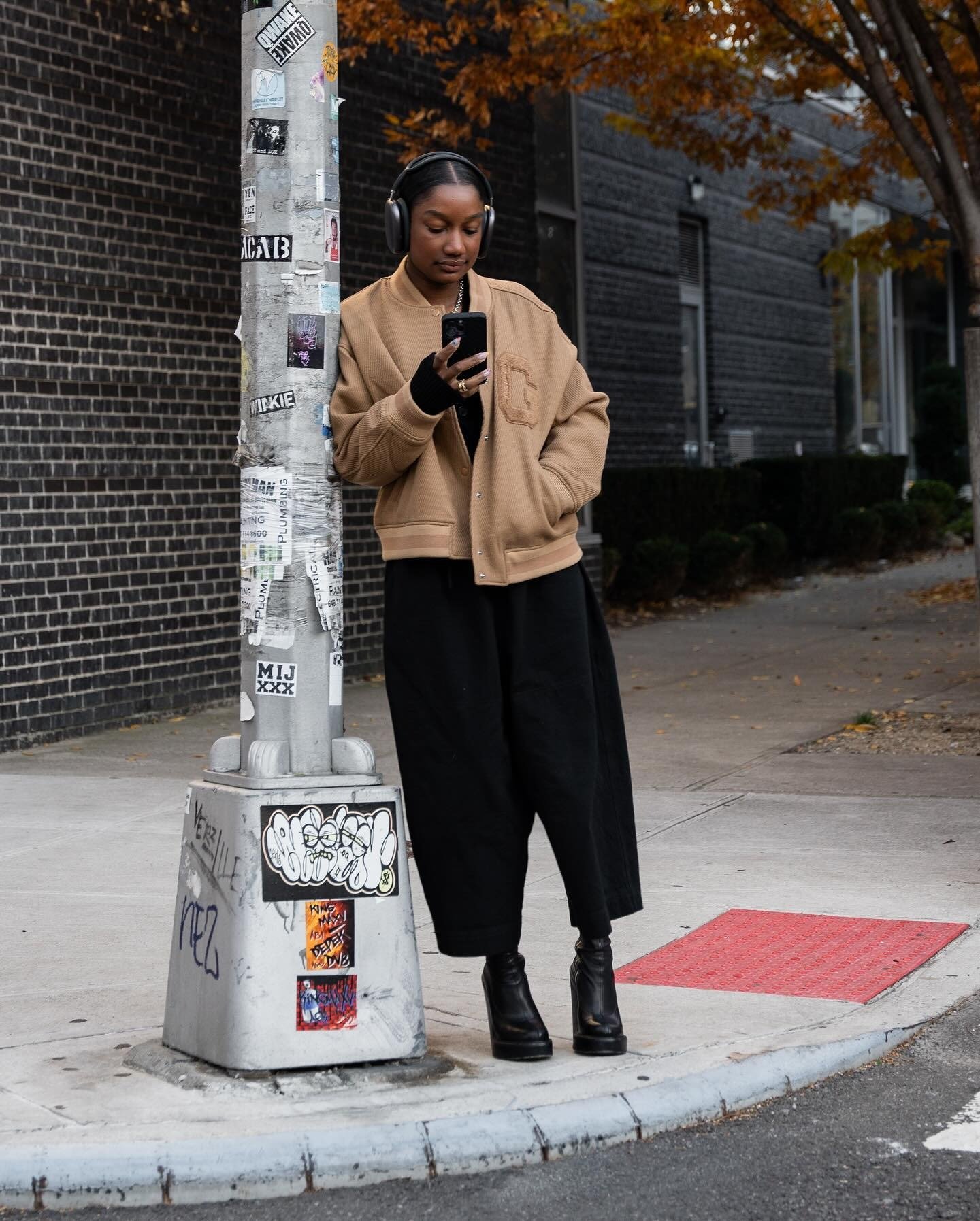 Telsha Anderson wearing black pants and a tan jacket in NYC.