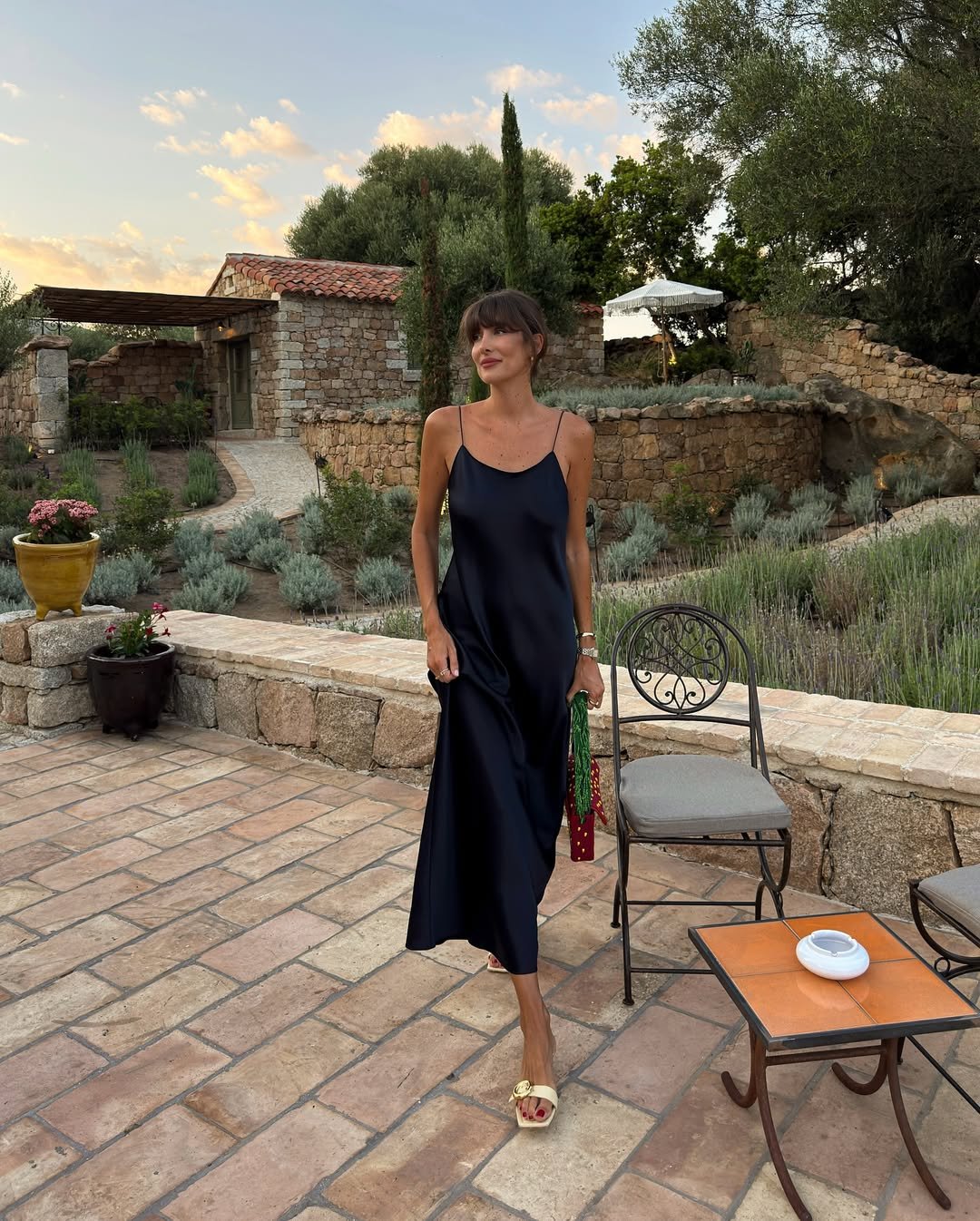 @juliesfi wears soft yellow sandals with a yellow dress