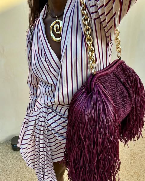 @spiritedpursuit wears a burgundy and white striped dress with a fringed burgundy handbag