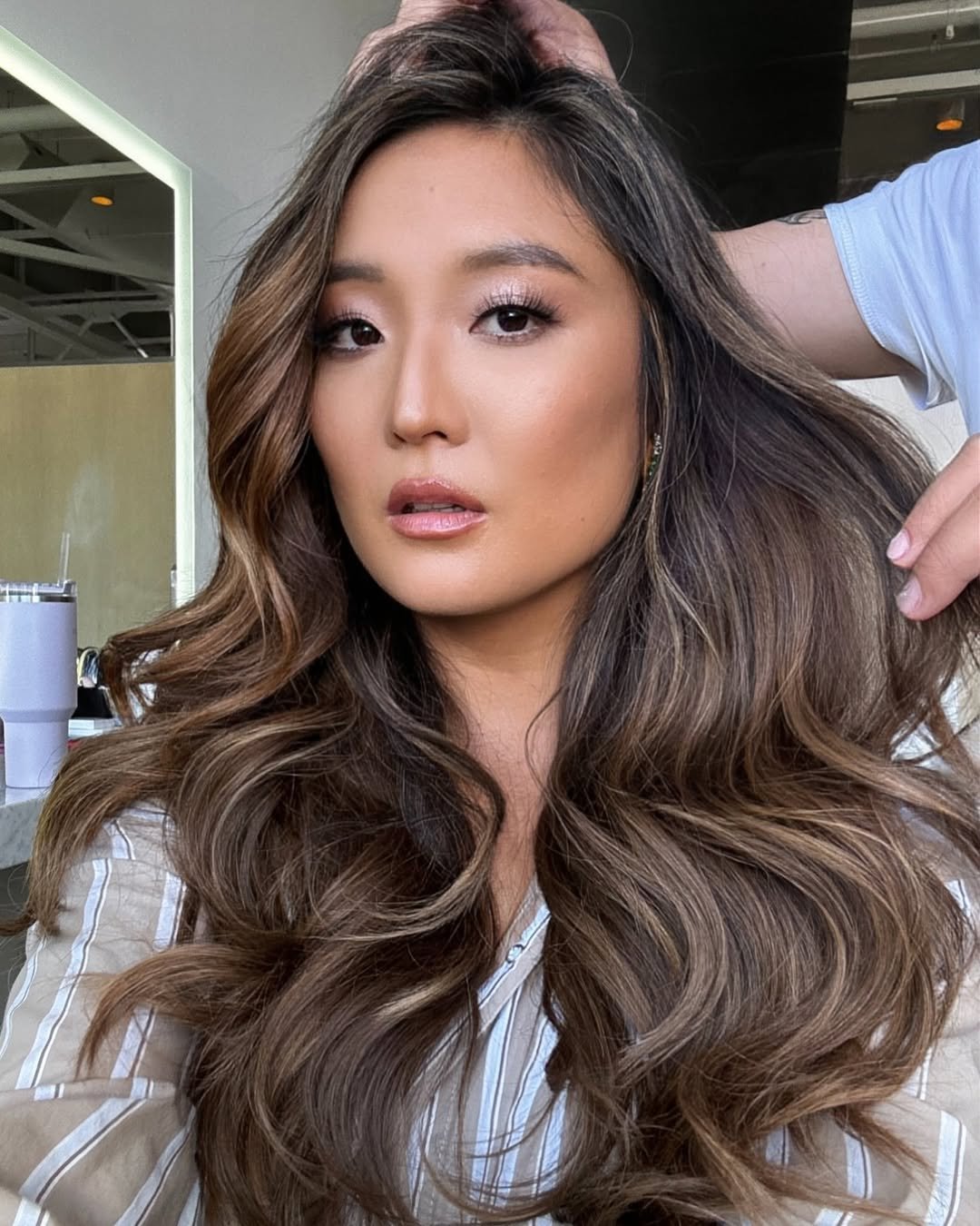 Ashley Park with ash brown hair by Clayton Hawkins