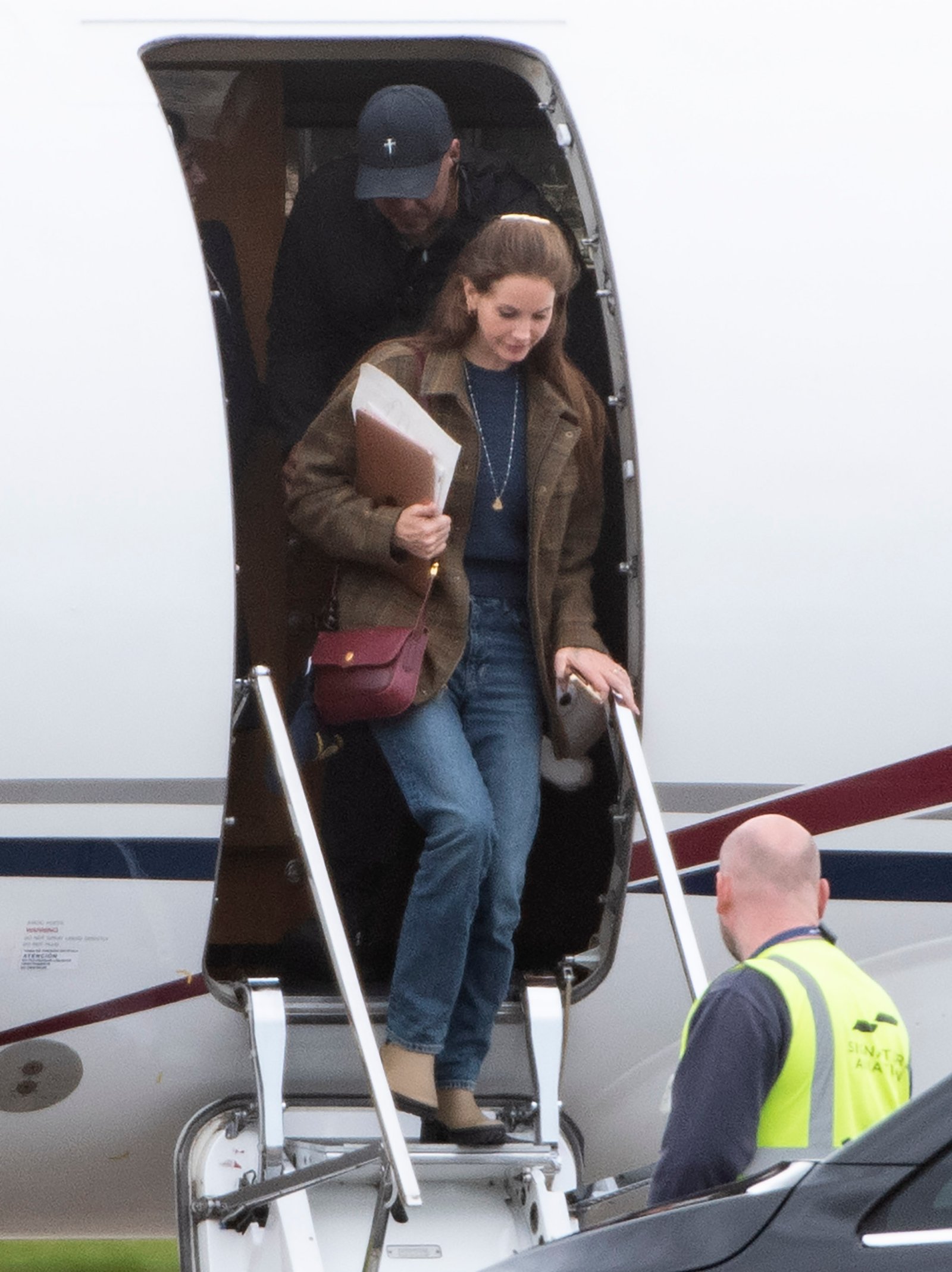 Lana Del Rey arriving for her tour in the UK wearing a brown blazer and jeans.