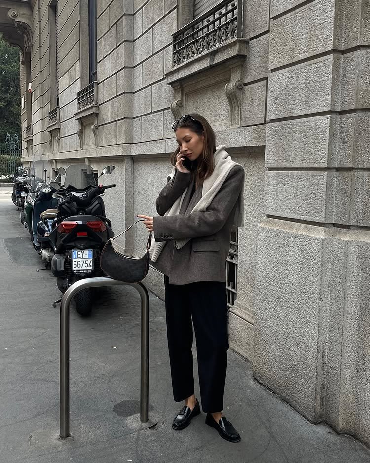 @fakerstrom wears a pair of black cropped trousers with a pair of black leather loafers and a taupe blazer