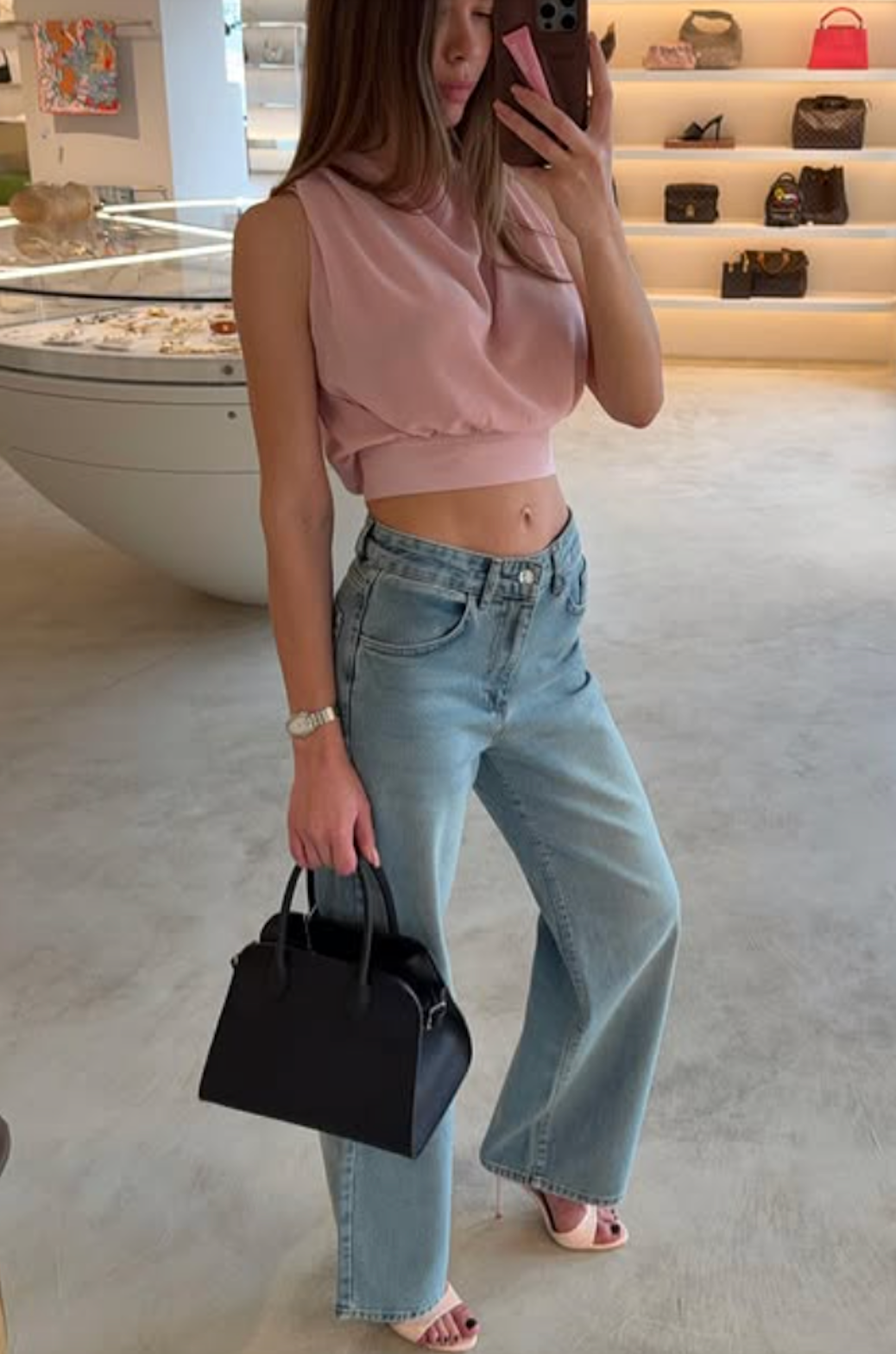 Woman wearing jeans with pointed peep-toe heels 2025.