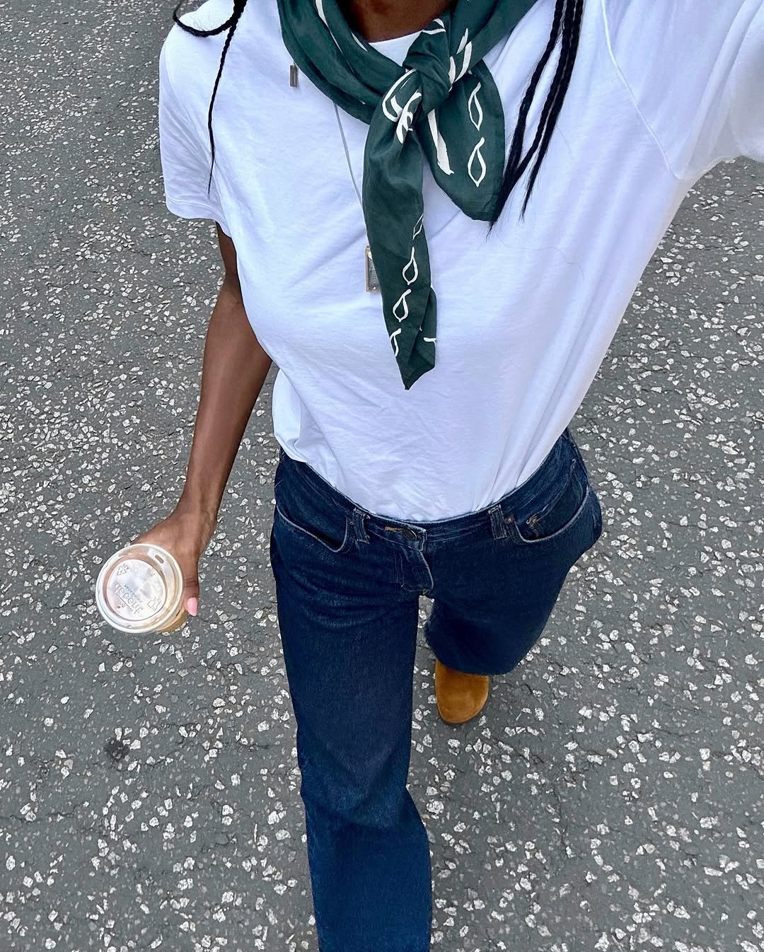 Woman wearing dark wash bootcut jeans fall 2025.