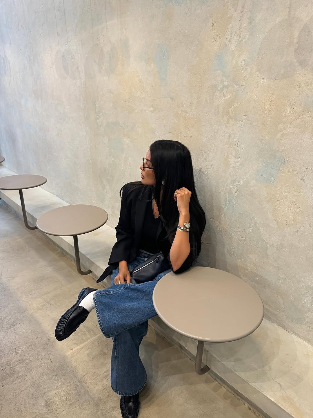 Woman wearing dark wash bootcut jeans fall 2025.
