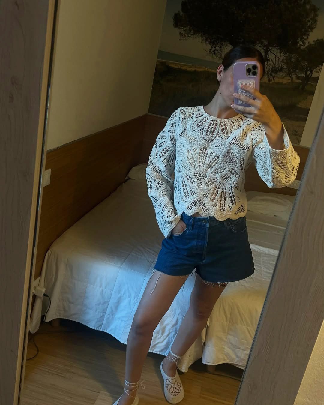 Influencer wearing denim shorts with a crochet top and crochet flats