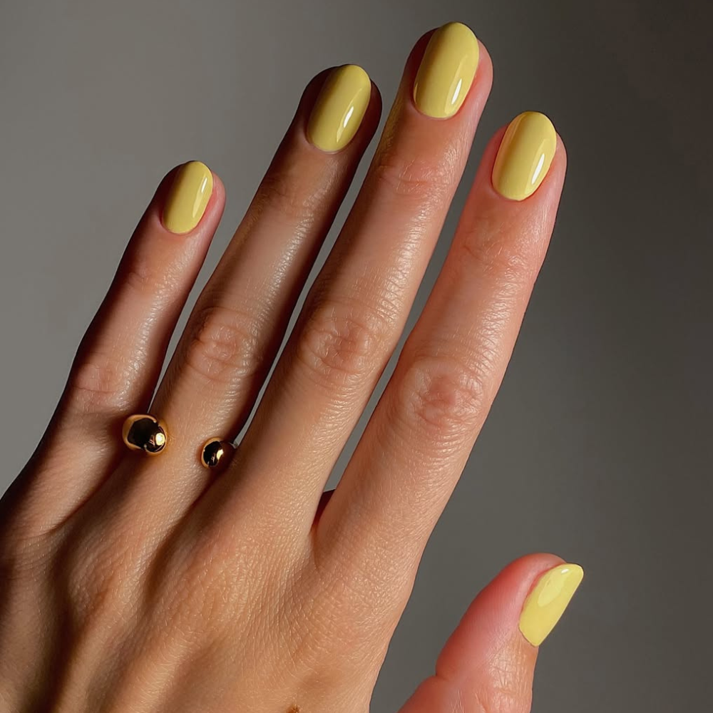 Close-up of a yellow manicure.