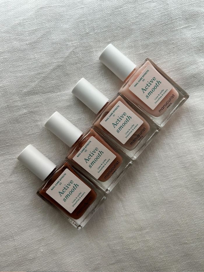 Pictures of the Manucurist Active Smooth nail polish on a white linen background