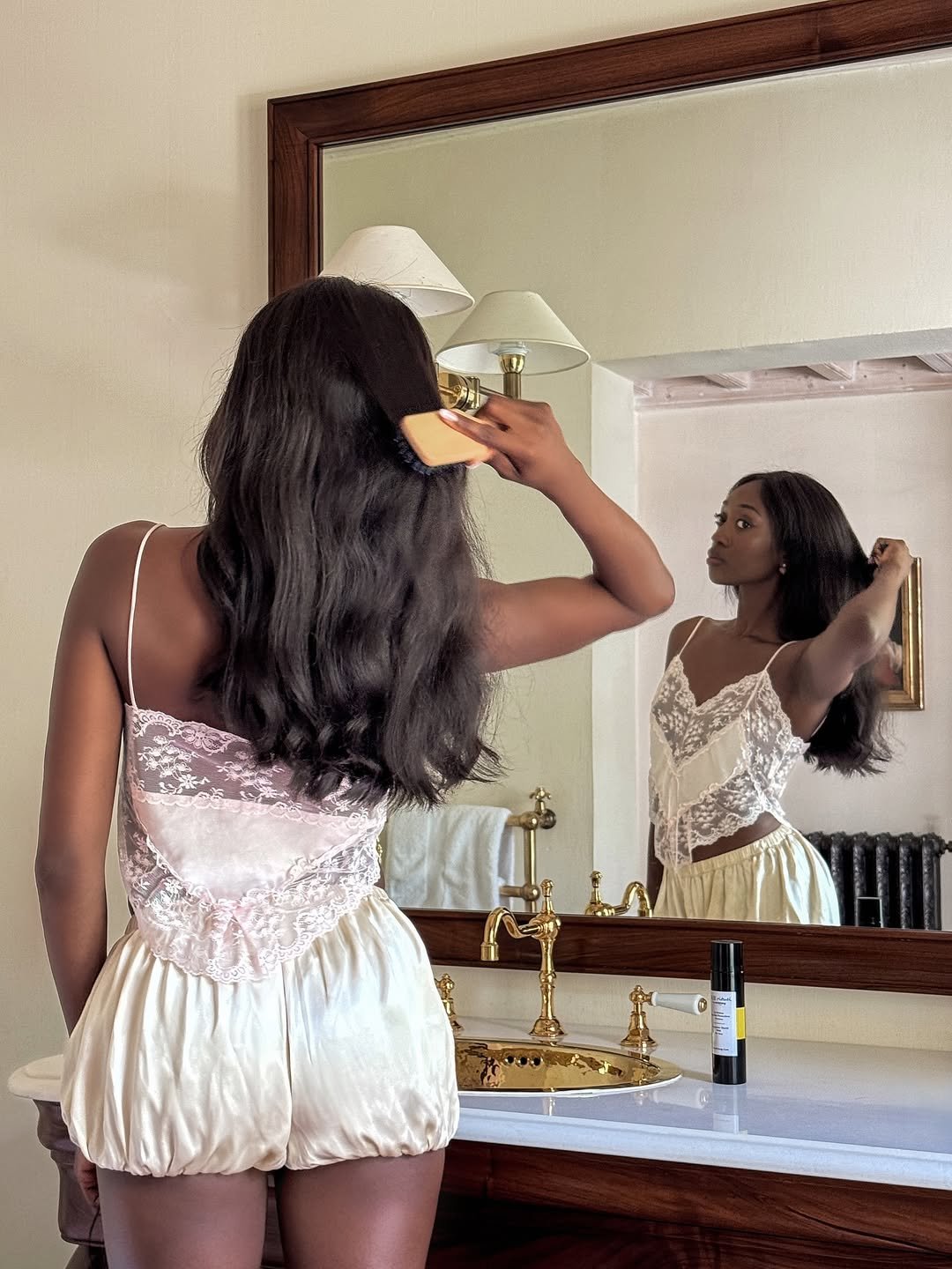 Emmanuelle Koffi brushing her hair while on a brand trip to Les Prés d'Eugénie.
