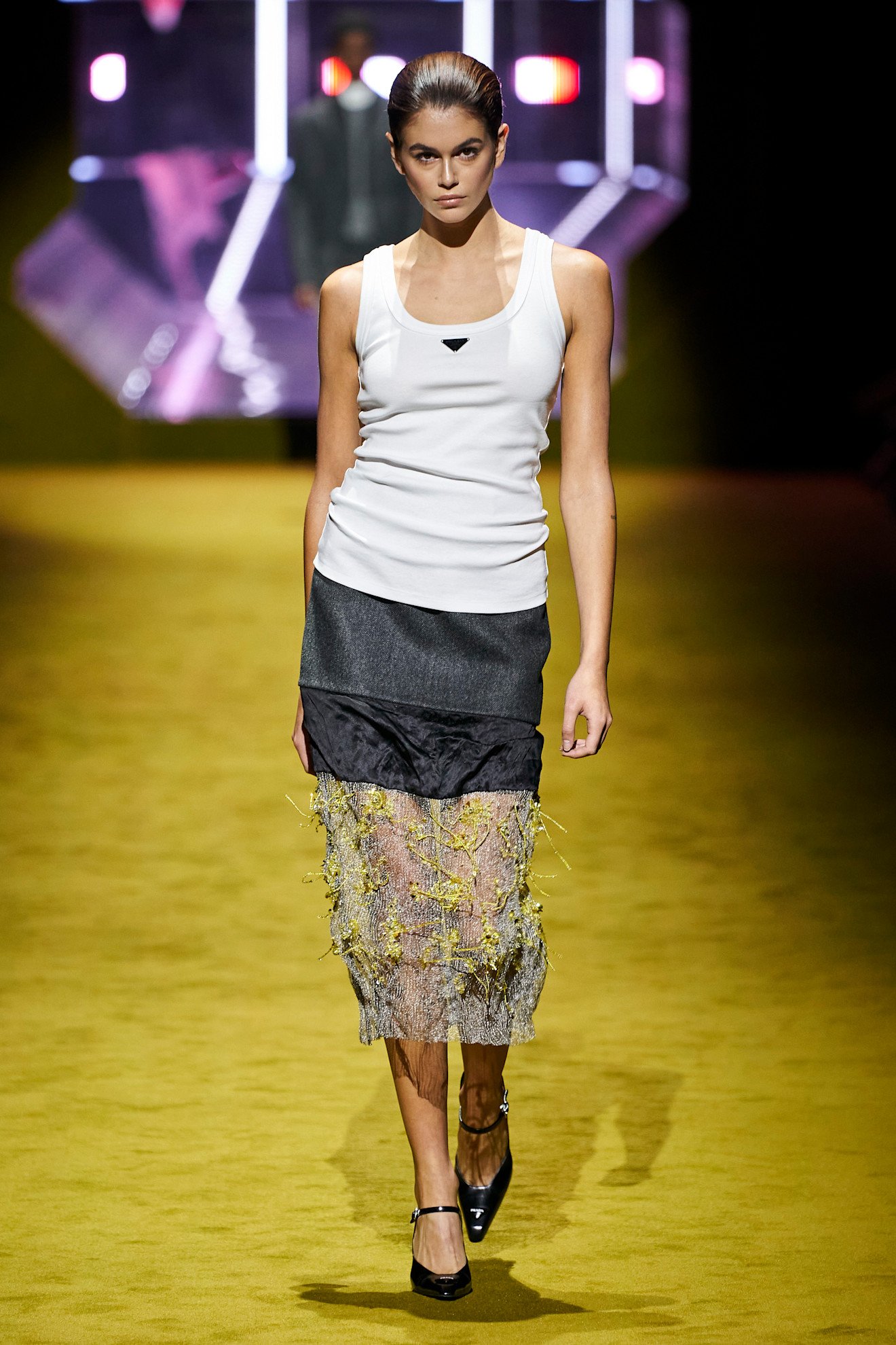 An image of a white tank top on Prada's autumn/winter 2022 runway.