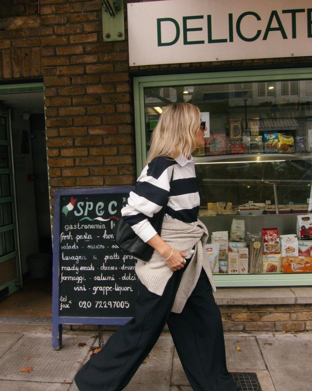 @lucywilliams02 wearing a striped rugby shirt with a tan sweater and trousers.