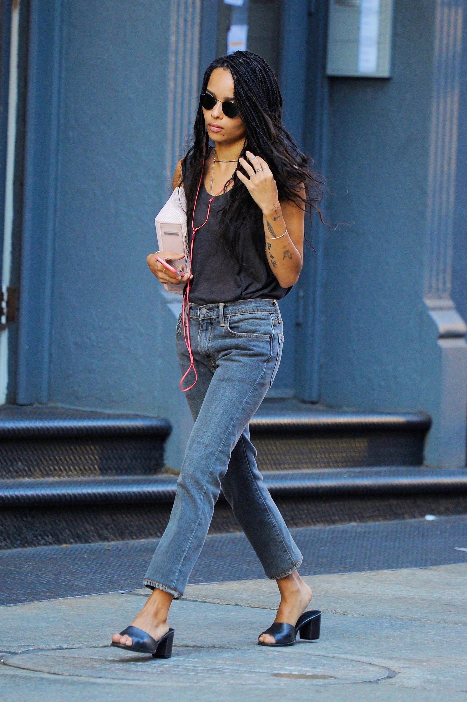 Zoe Kravitz wears a black tank, skinny jeans and leather mules walking the streets of SoHo in 2016 in an image taken from Getty images.
