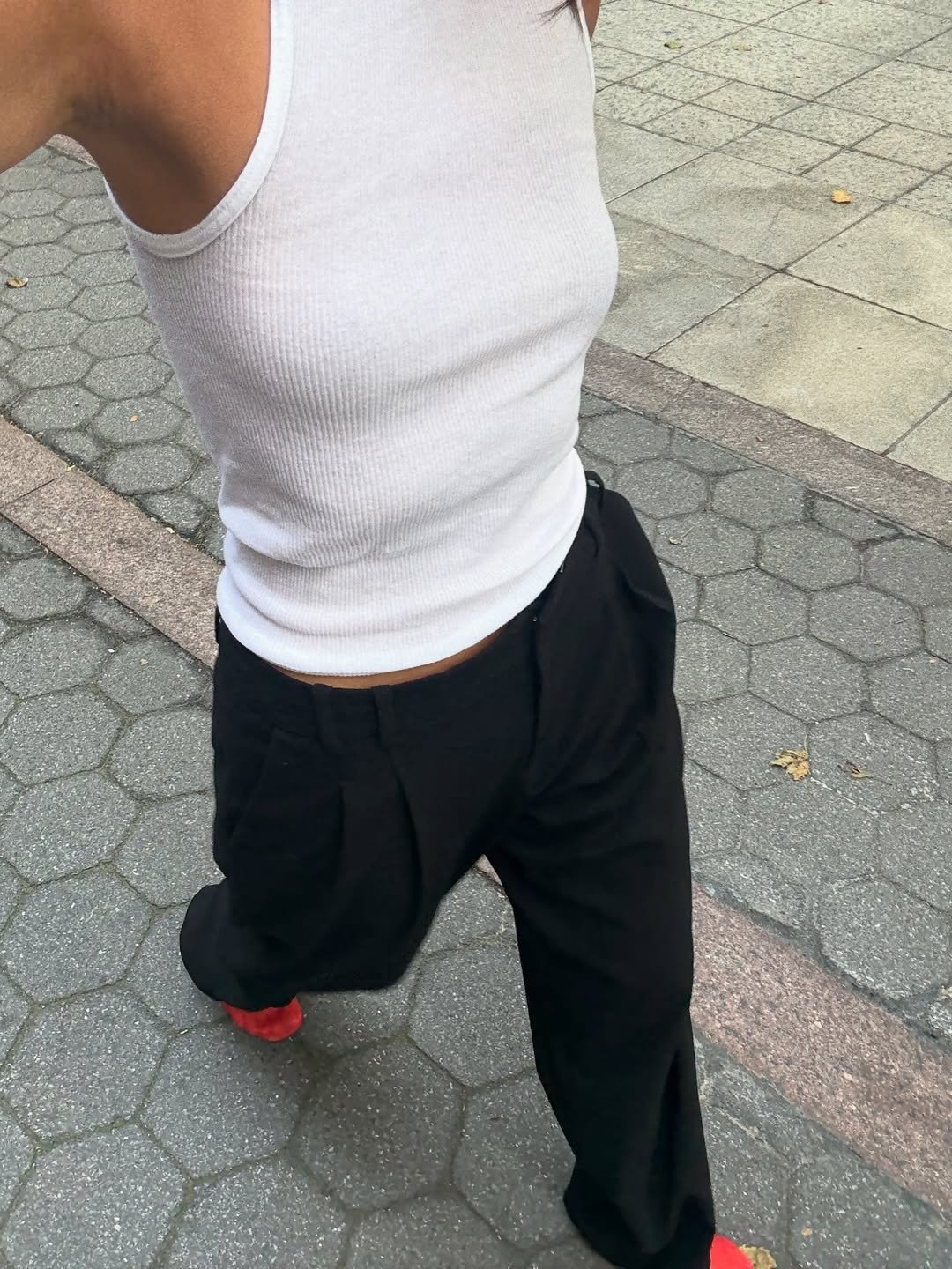 @mimixn wears red mesh flats with black trousers and a white tank top