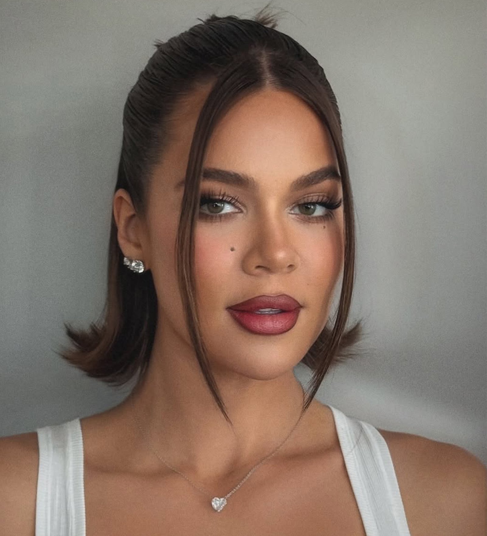 A half-up half down flipped bob on Khloe Kardashian by Justine Marjan